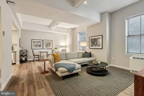 a living room with furniture a rug and a window