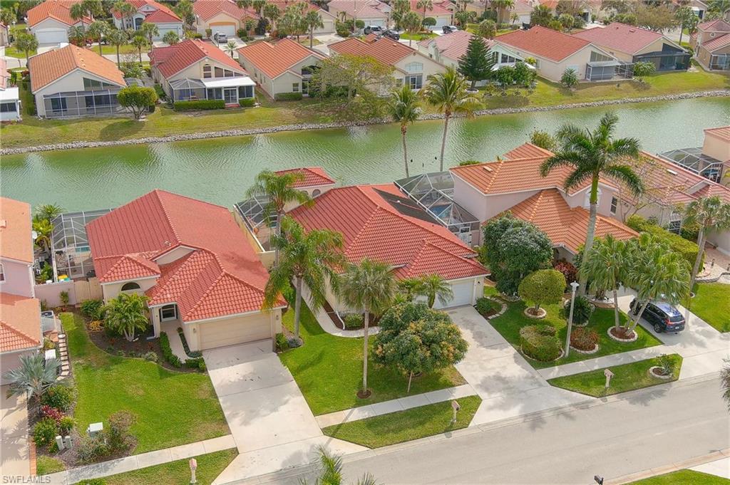 156 Sabal Lake Drive Naples, FL 34104 - Photo 1 of 40 an aerial view of residential houses with outdoor space and lake view