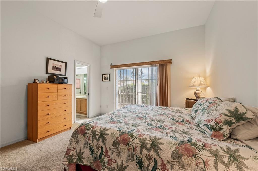156 Sabal Lake Drive Naples, FL 34104 - Photo 15 of 40 a bedroom with a bed and a closet