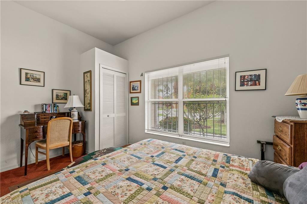 156 Sabal Lake Drive Naples, FL 34104 - Photo 18 of 40 a bedroom with a bed and wooden floor