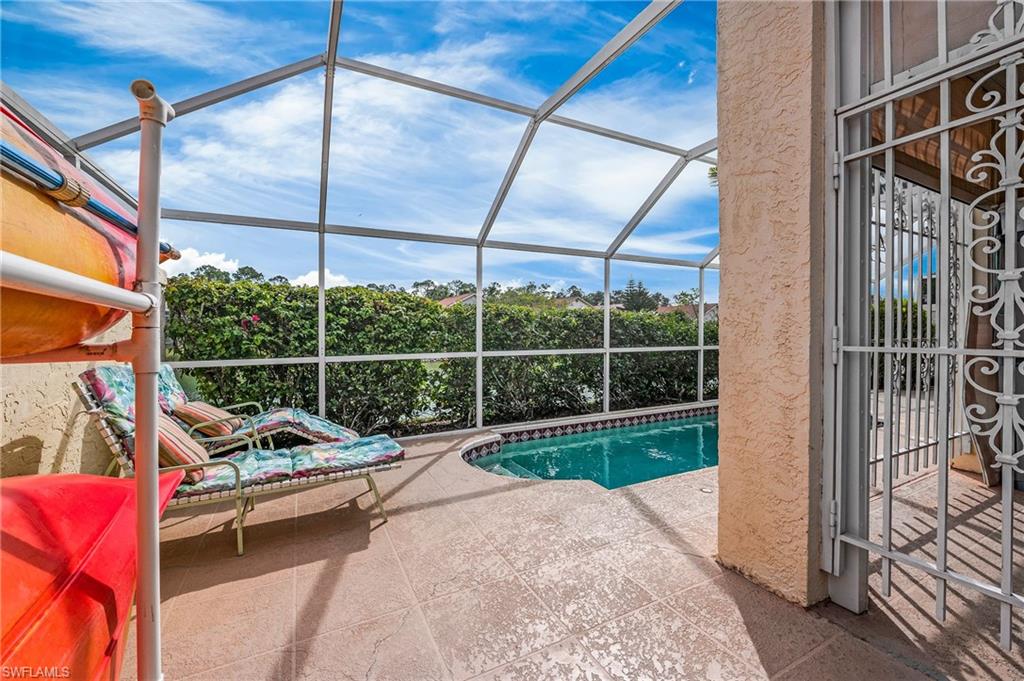 156 Sabal Lake Drive Naples, FL 34104 - Photo 22 of 40 a view of a deck with a floor to ceiling window and wooden floor