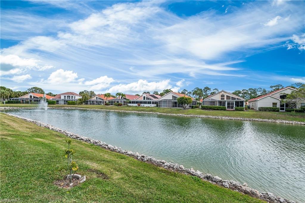 156 Sabal Lake Drive Naples, FL 34104 - Photo 24 of 40 a view of a lake with houses in the back