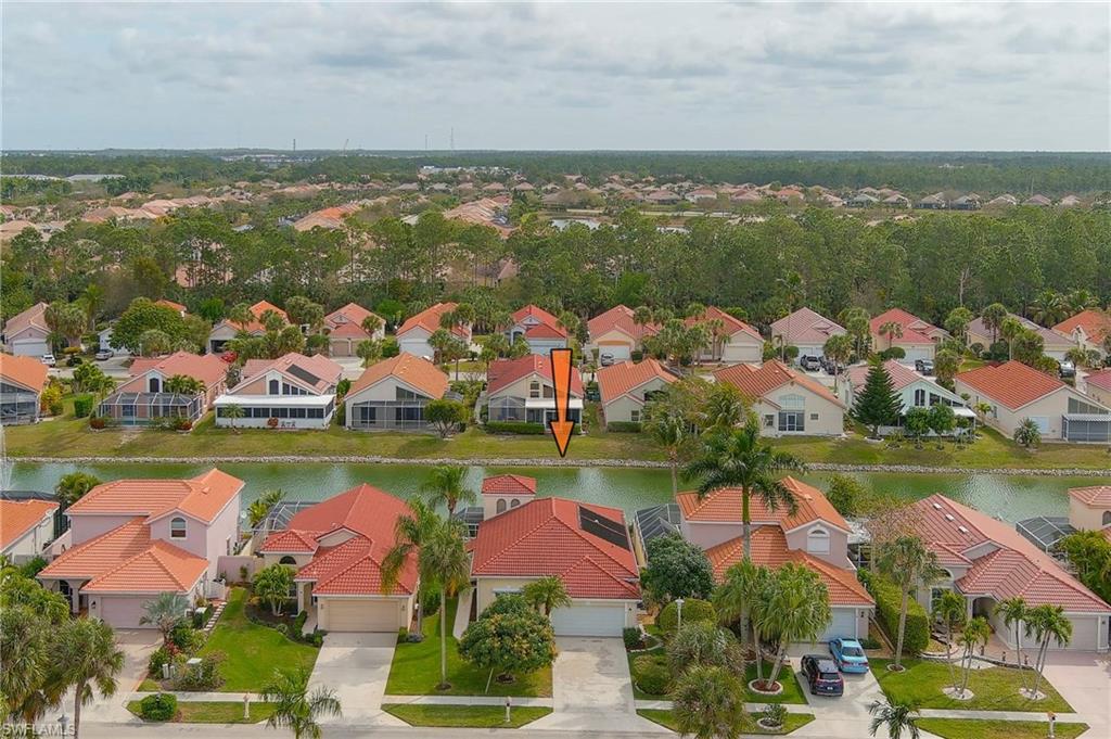 156 Sabal Lake Drive Naples, FL 34104 - Photo 25 of 40 an aerial view of residential houses with outdoor space lake and green space