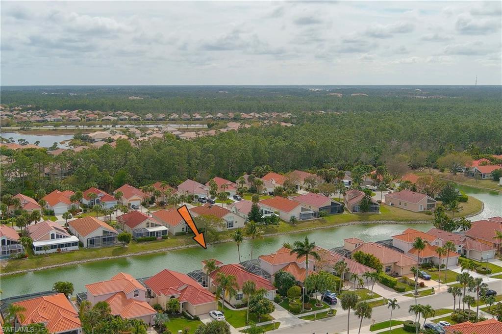 156 Sabal Lake Drive Naples, FL 34104 - Photo 26 of 40 a view of a lake with houses with outdoor space