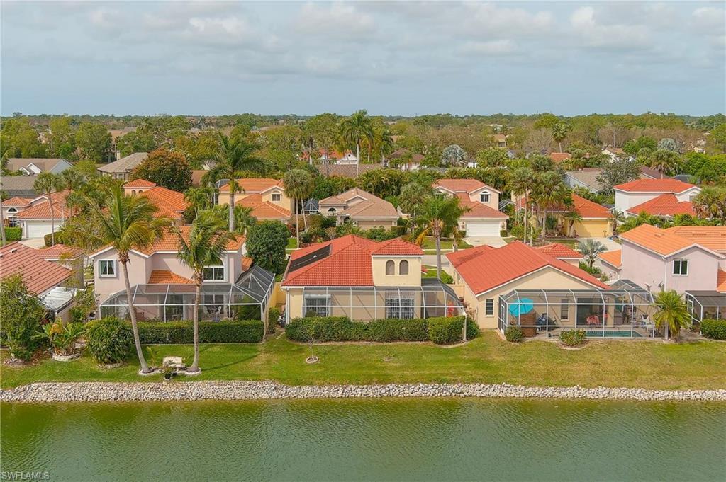 156 Sabal Lake Drive Naples, FL 34104 - Photo 28 of 40 an aerial view of residential houses with swimming pool and ocean view