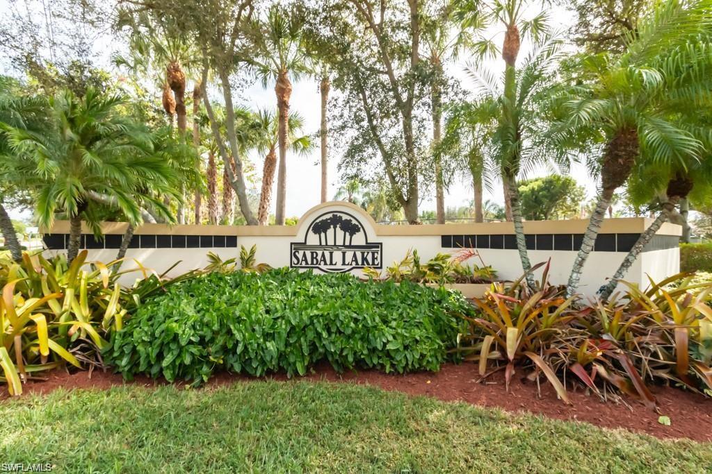 156 Sabal Lake Drive Naples, FL 34104 - Photo 29 of 40 a view of a bench in a garden