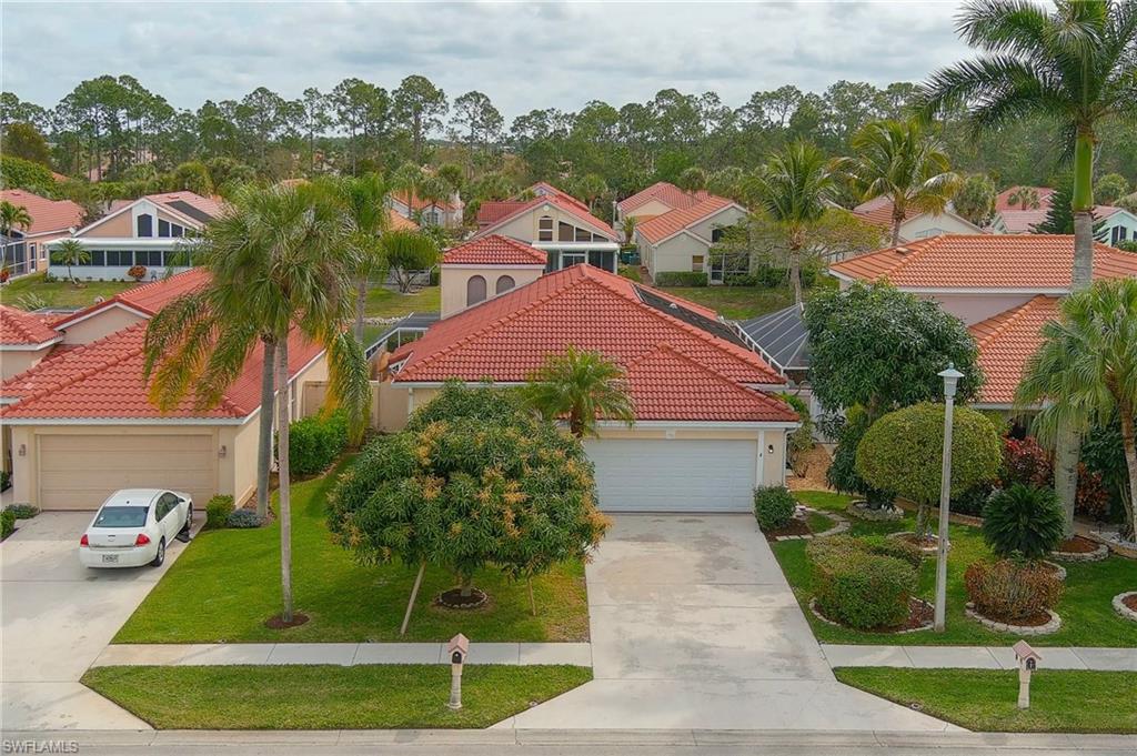 156 Sabal Lake Drive Naples, FL 34104 - Photo 3 of 40 a view of a house with a yard and potted plants