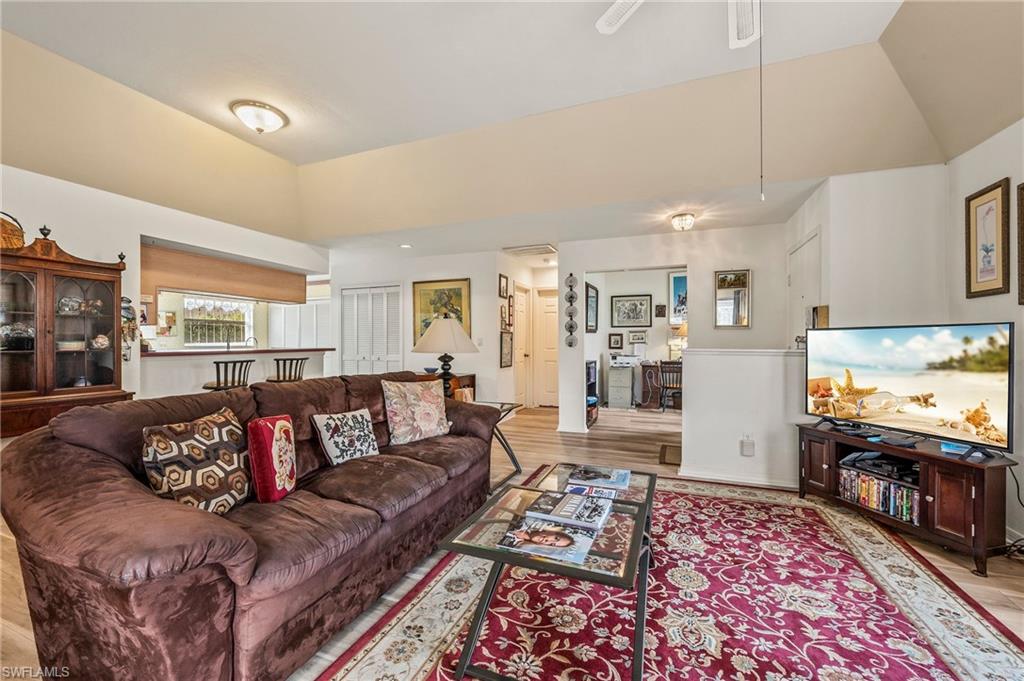 156 Sabal Lake Drive Naples, FL 34104 - Photo 5 of 40 a living room with furniture and a flat screen tv