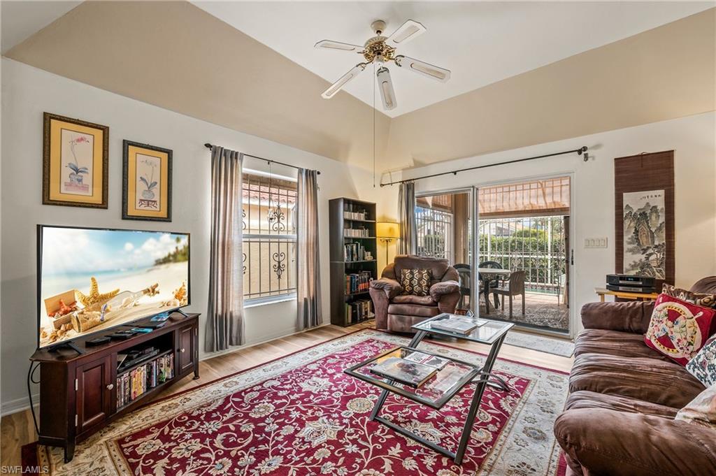 156 Sabal Lake Drive Naples, FL 34104 - Photo 6 of 40 a living room with furniture and a flat screen tv