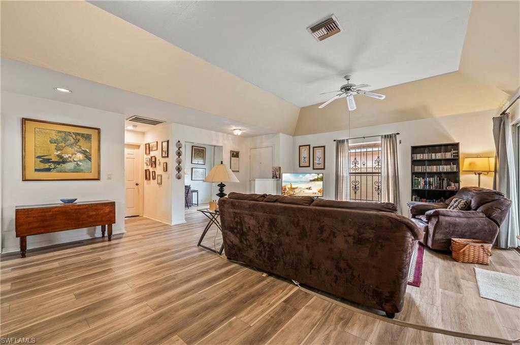 156 Sabal Lake Drive Naples, FL 34104 - Photo 8 of 40 a living room with furniture and a wooden floor