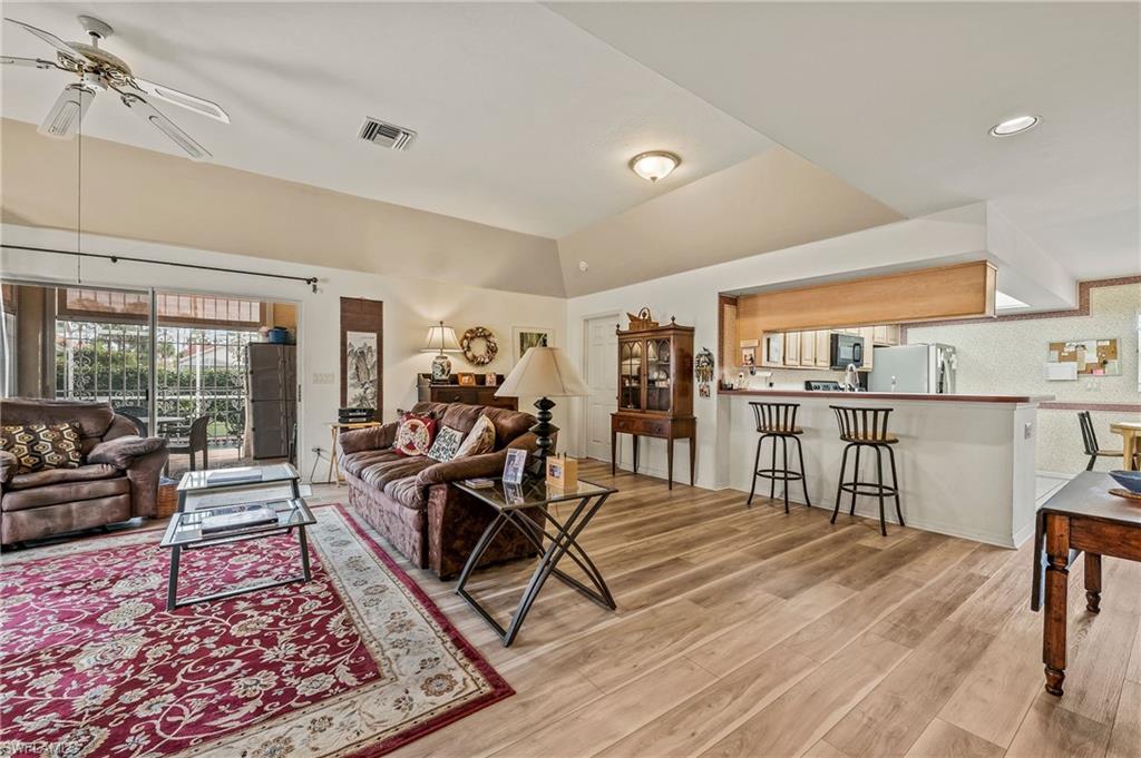 156 Sabal Lake Drive Naples, FL 34104 - Photo 9 of 40 a living room with furniture and wooden floor