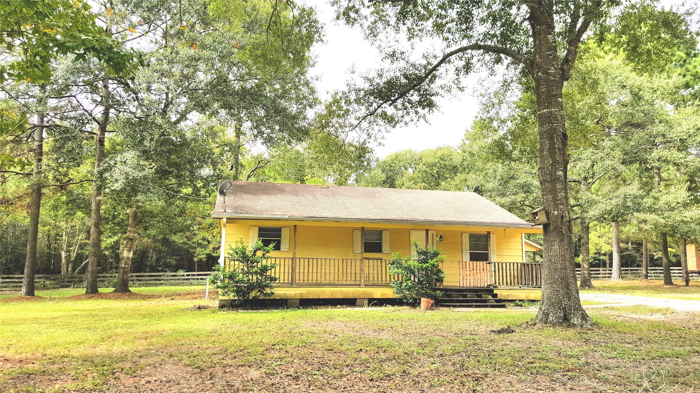 a front view of a house with swimming pool and porch with furniture