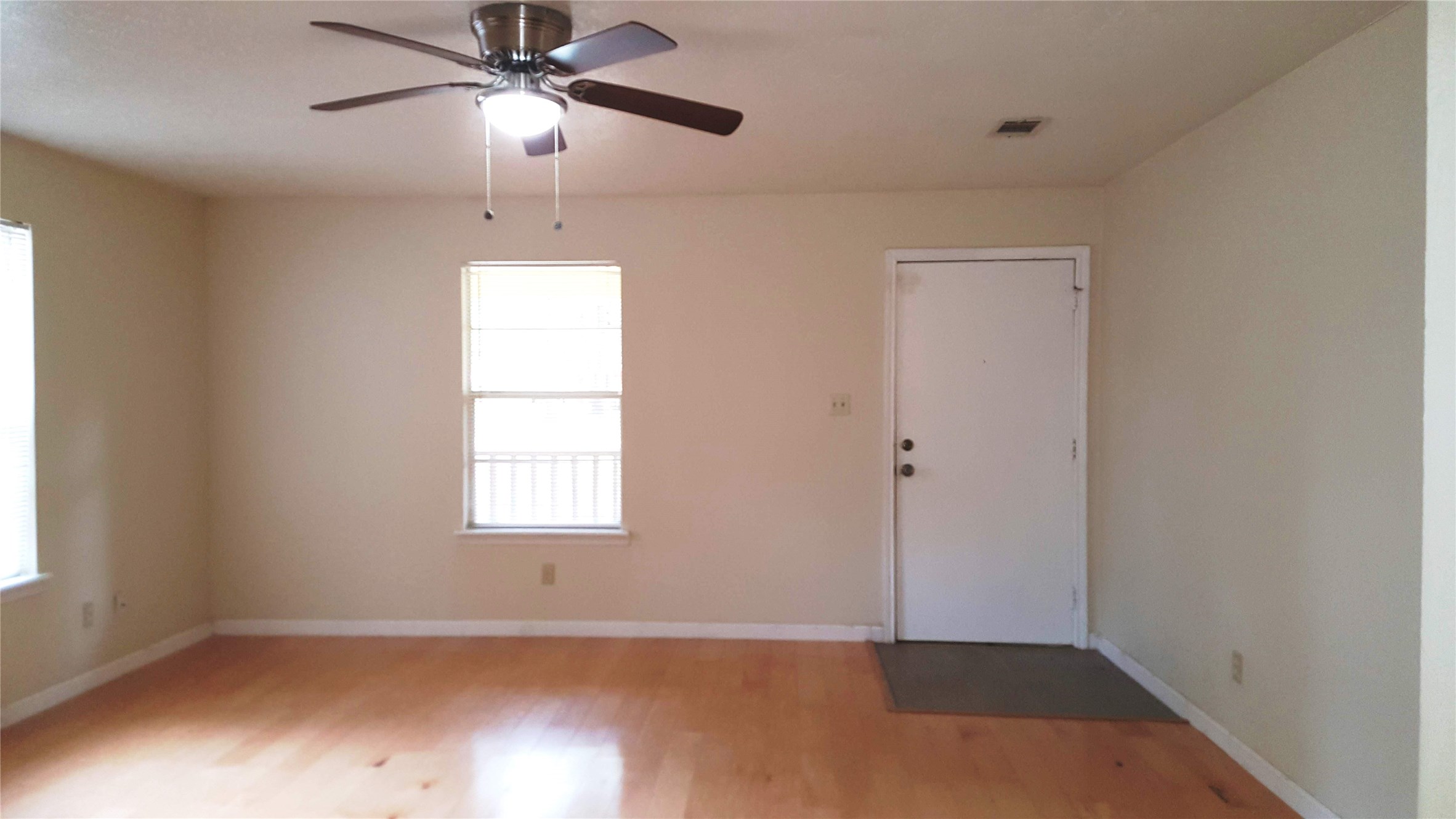 12105 Old County Road Willis, TX 77378 - Photo 3 of 13 an empty room with windows and fan