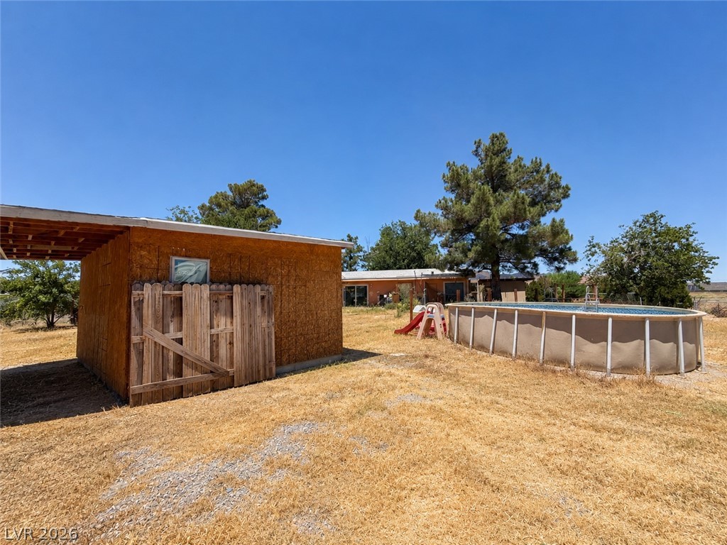1611 West Blosser Ranch Road Pahrump, NV 89060 - Photo 21 of 25 An inviting above-ground pool and shed complement this home's ample yard space.