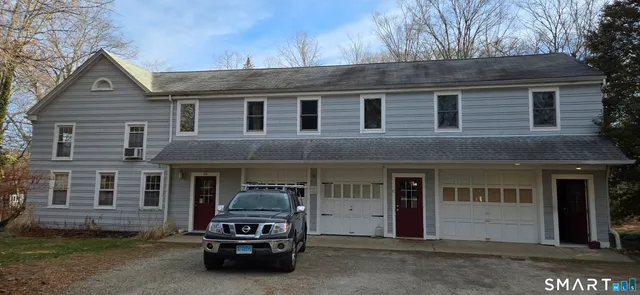 a car parked in front of a brick house