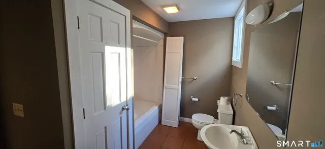 a bathroom with a toilet a sink and bathtub