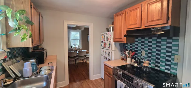 a kitchen with a stove and a refrigerator