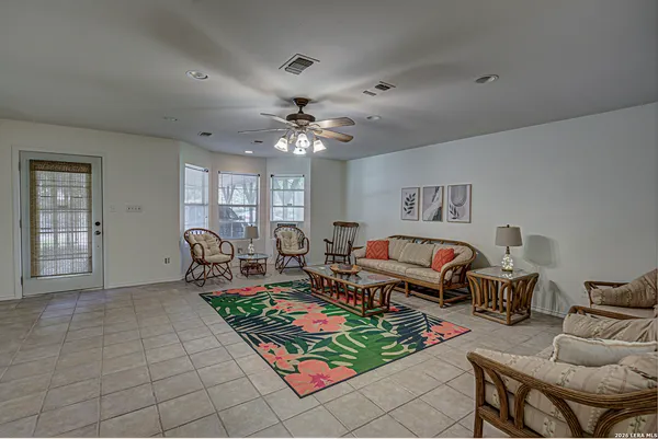 a view of a livingroom with a chandelier fan