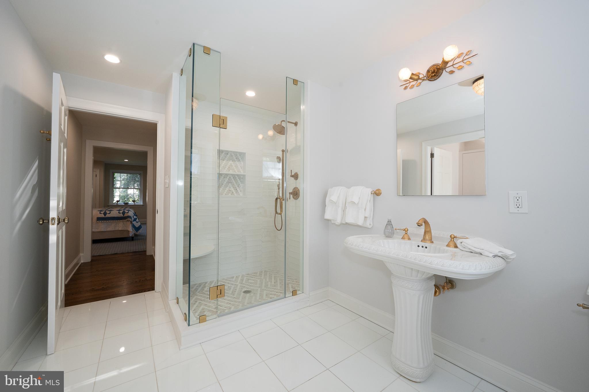 510 Lynmere Road Bryn Mawr, PA 19010 - Photo 22 of 44 a bathroom with a sink mirror and shower