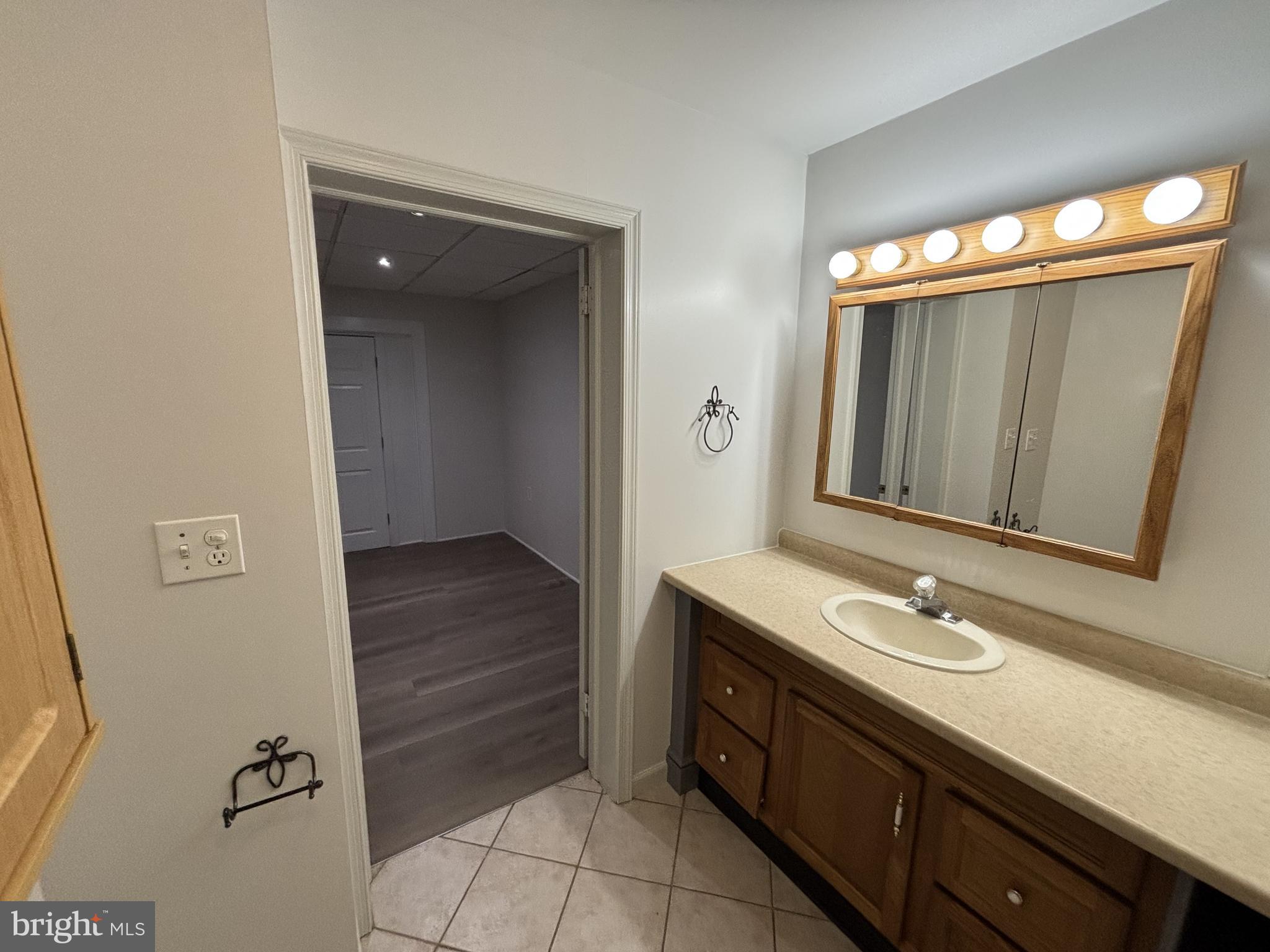 401 Main Street, Unit A Denver, PA 17517 - Photo 11 of 12 a bathroom with a sink a mirror and a toilet