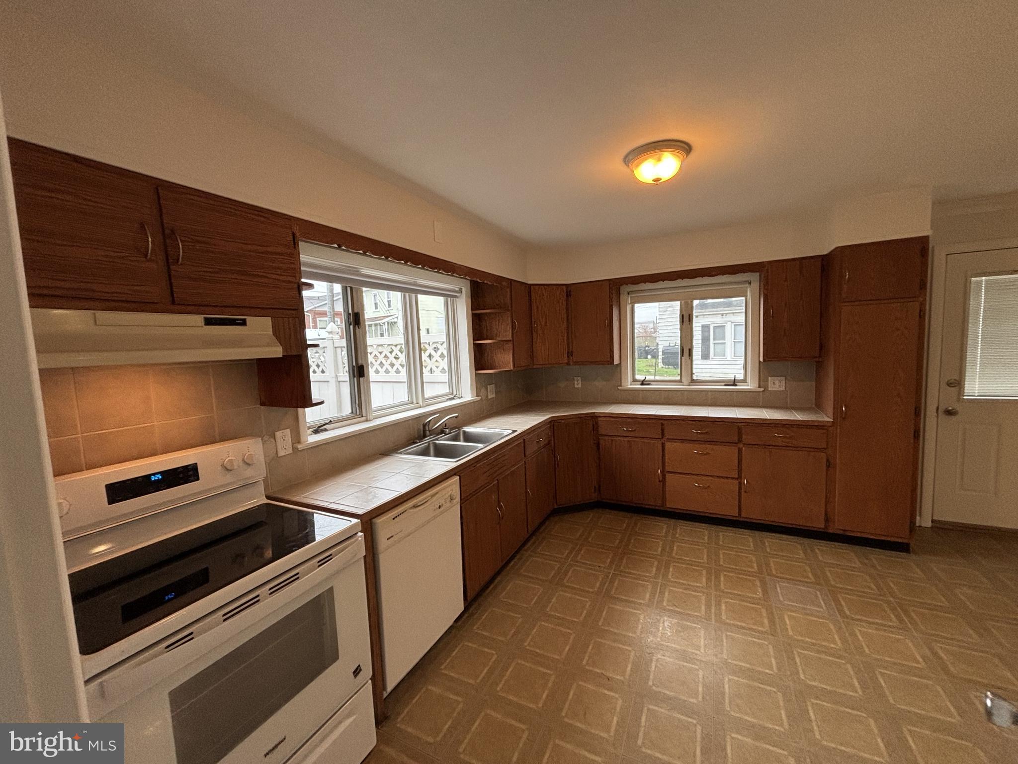 401 Main Street, Unit A Denver, PA 17517 - Photo 3 of 12 a kitchen with stainless steel appliances a stove sink and cabinets