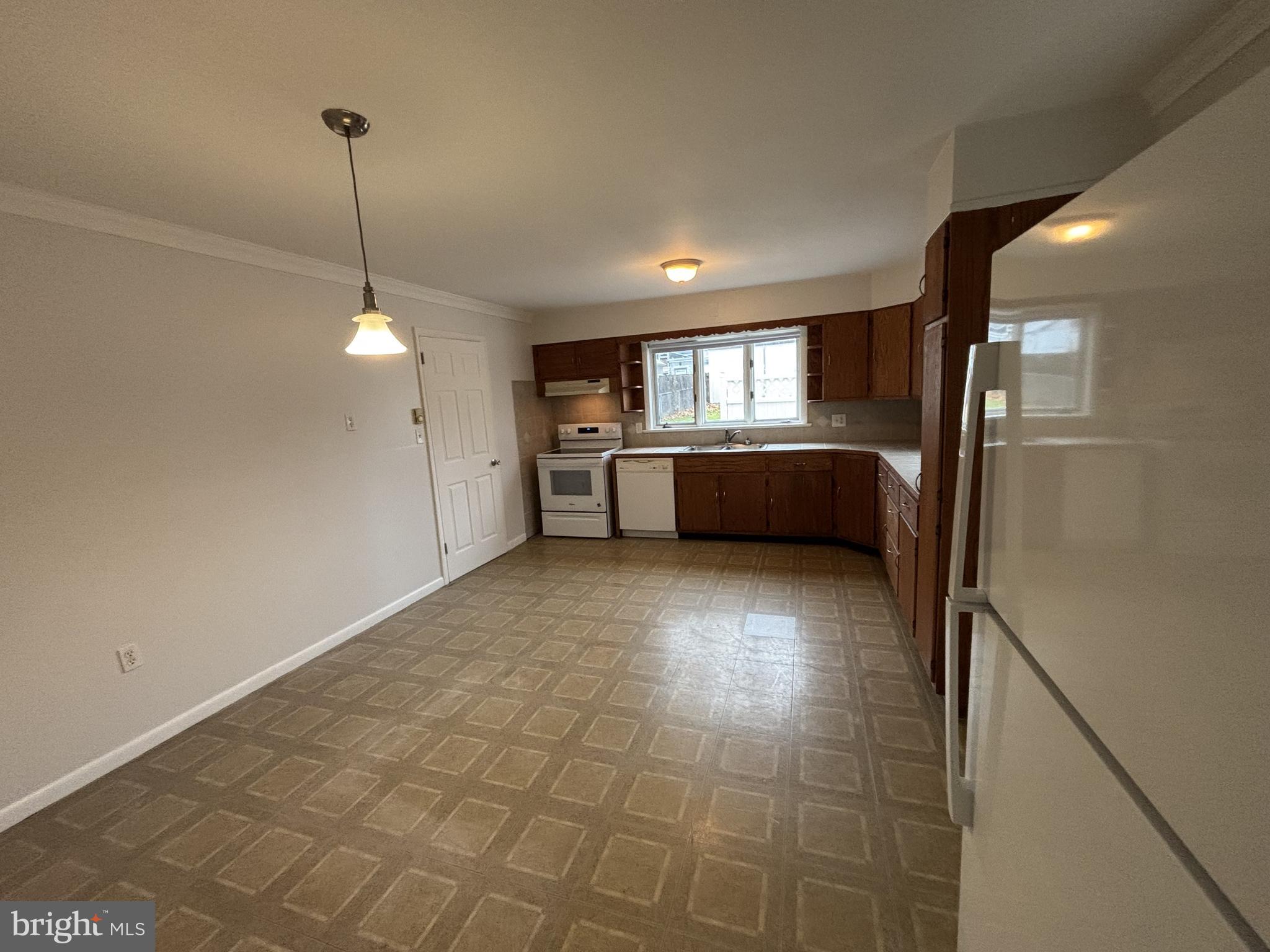 401 Main Street, Unit A Denver, PA 17517 - Photo 4 of 12 a kitchen with stainless steel appliances a refrigerator and a sink