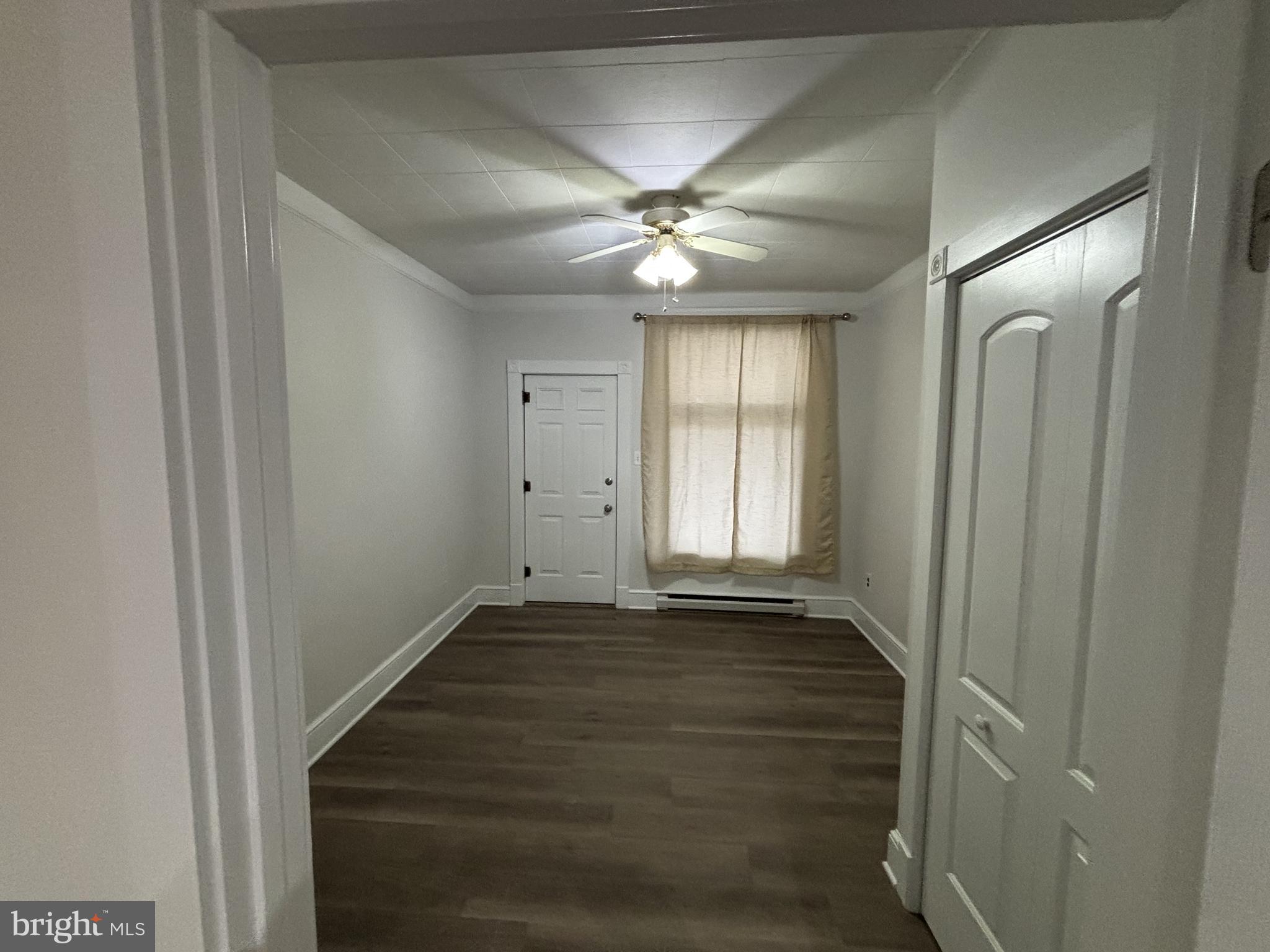 401 Main Street, Unit A Denver, PA 17517 - Photo 8 of 12 an empty room with wooden floor and windows