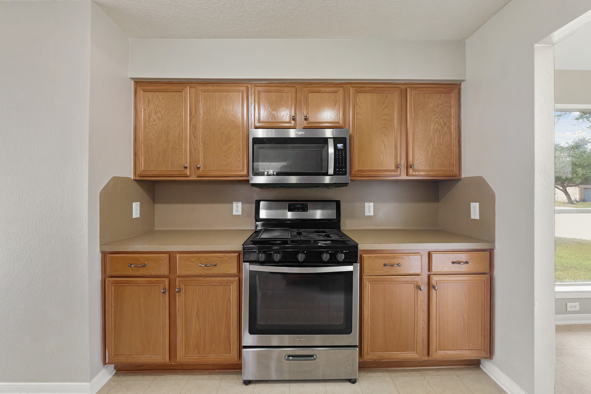 20410 Fall Foliage Drive Humble, TX 77338 - Photo 11 of 35 a kitchen with a stove and a microwave