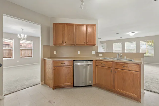 a kitchen with granite countertop a sink and stainless steel appliances