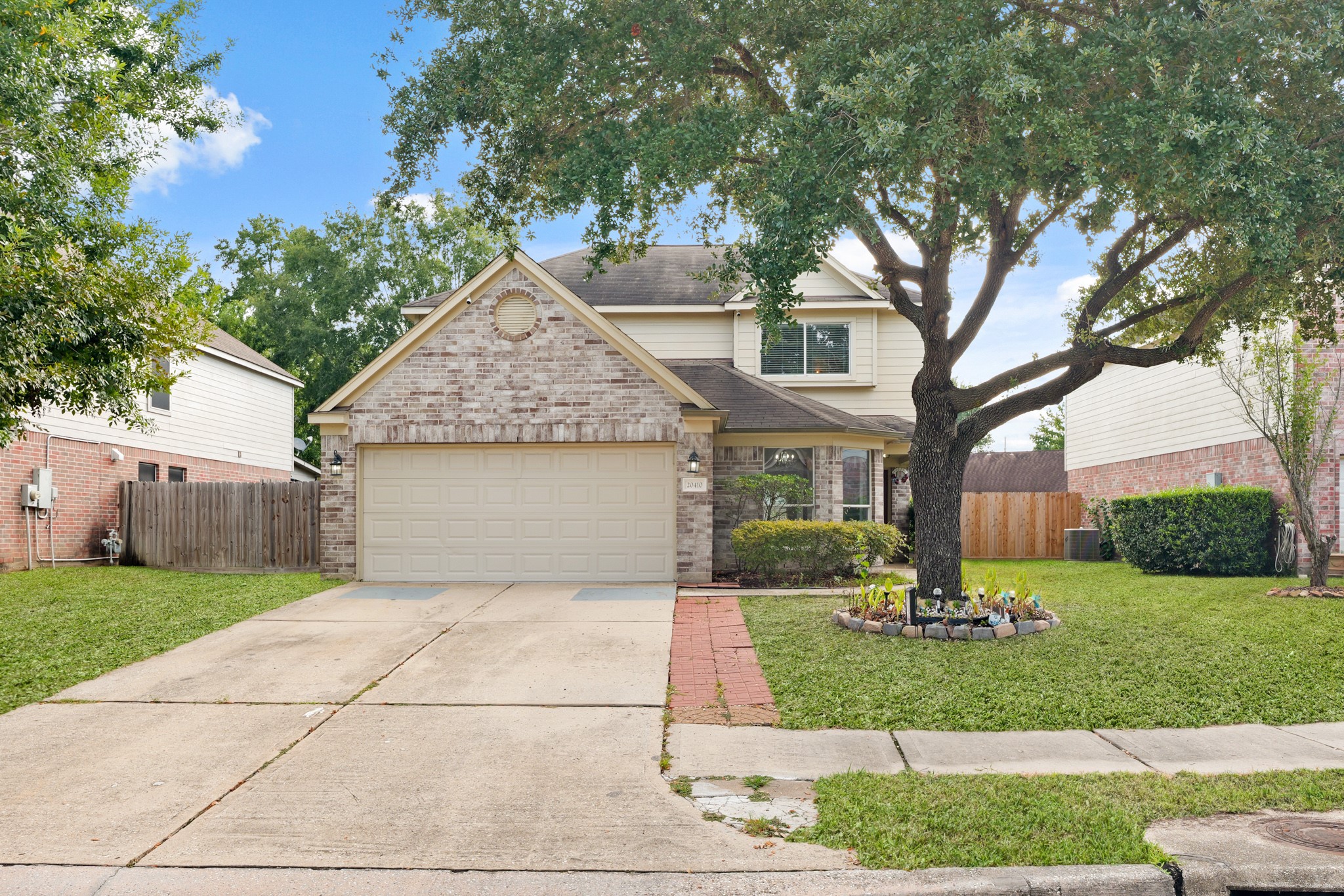 20410 Fall Foliage Drive Humble, TX 77338 - Photo 2 of 35 a front view of a house with a yard and trees