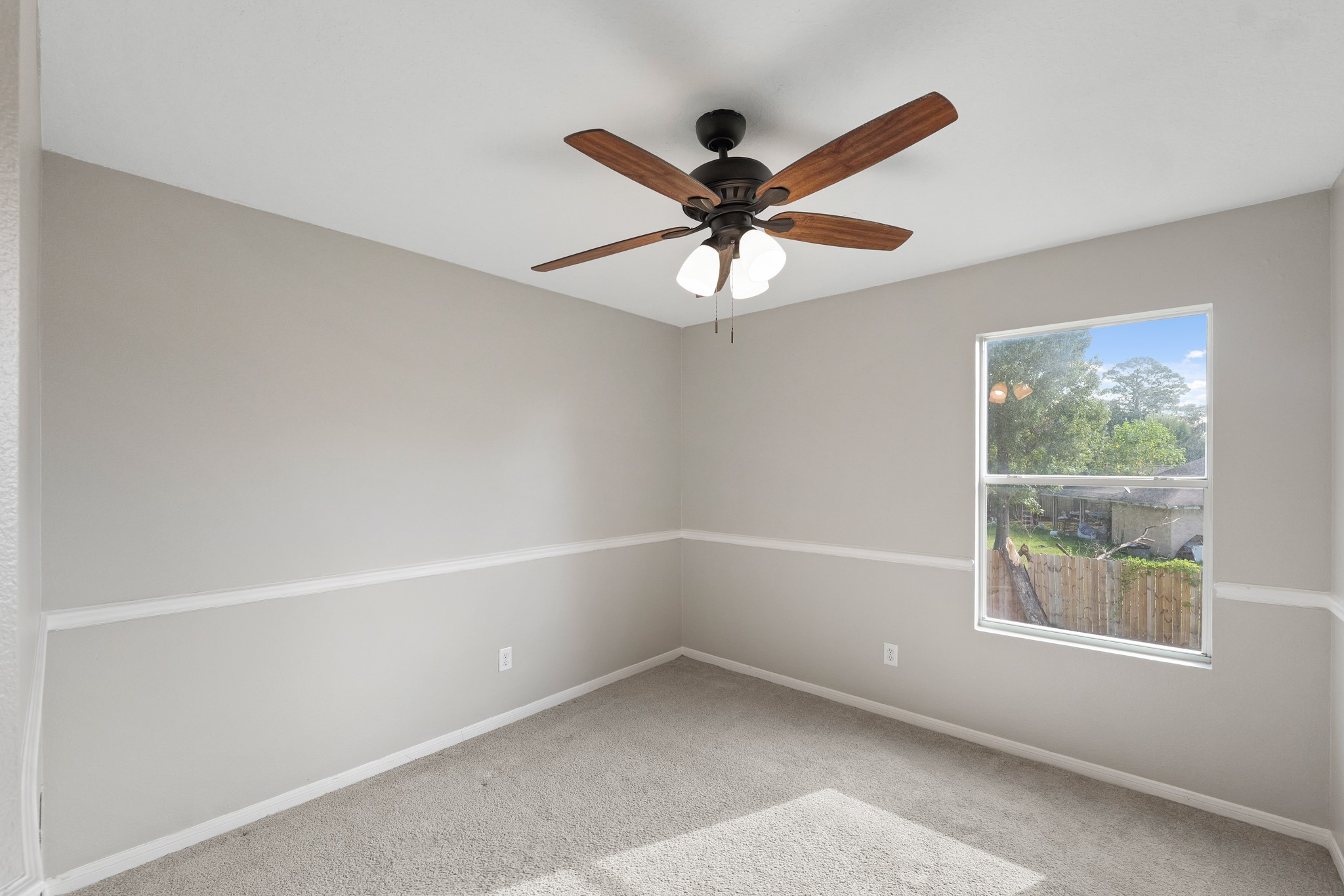 20410 Fall Foliage Drive Humble, TX 77338 - Photo 22 of 35 an empty room with a window and a fan