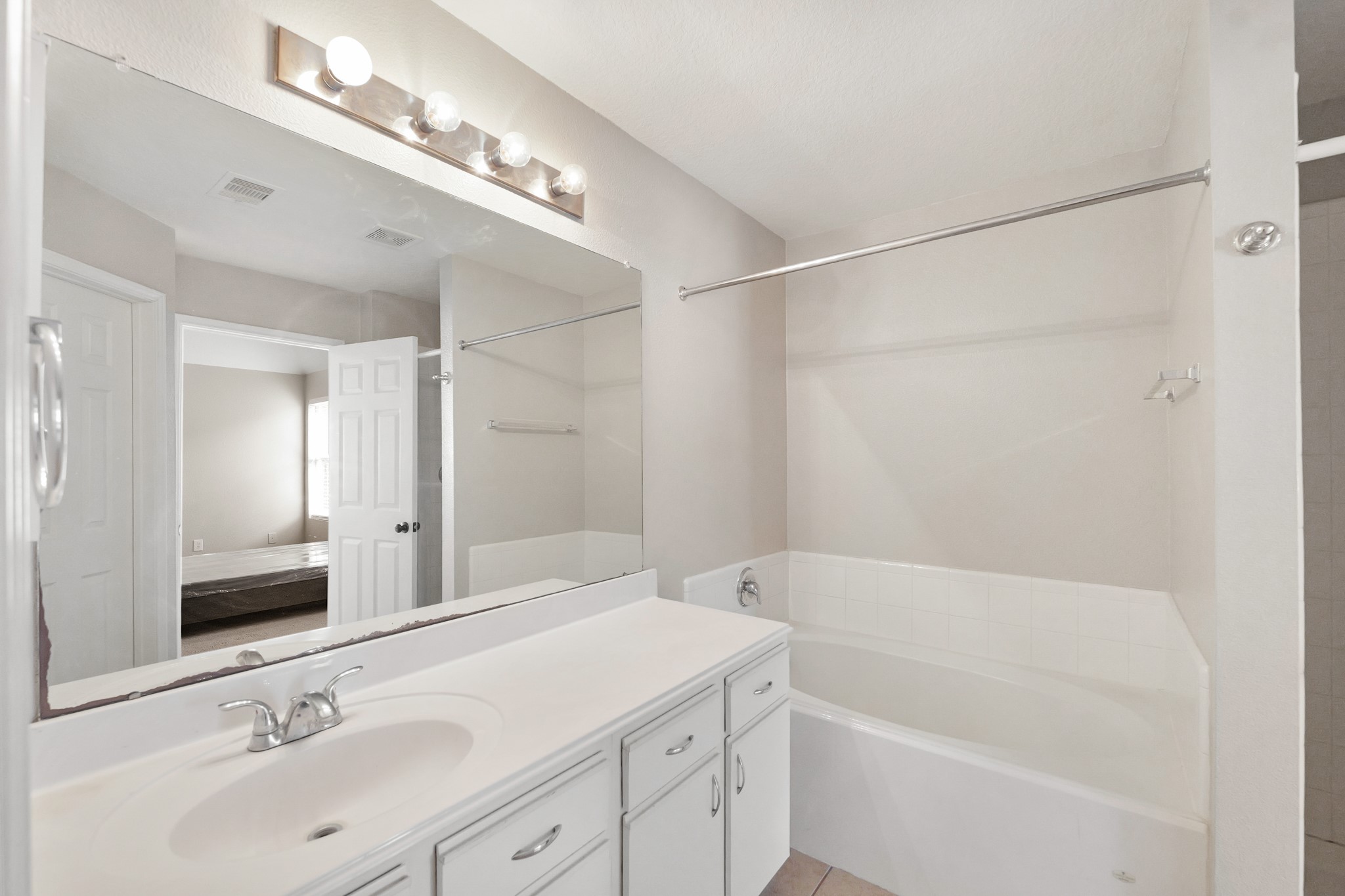 20410 Fall Foliage Drive Humble, TX 77338 - Photo 29 of 35 a bathroom with a tub a sink and mirror