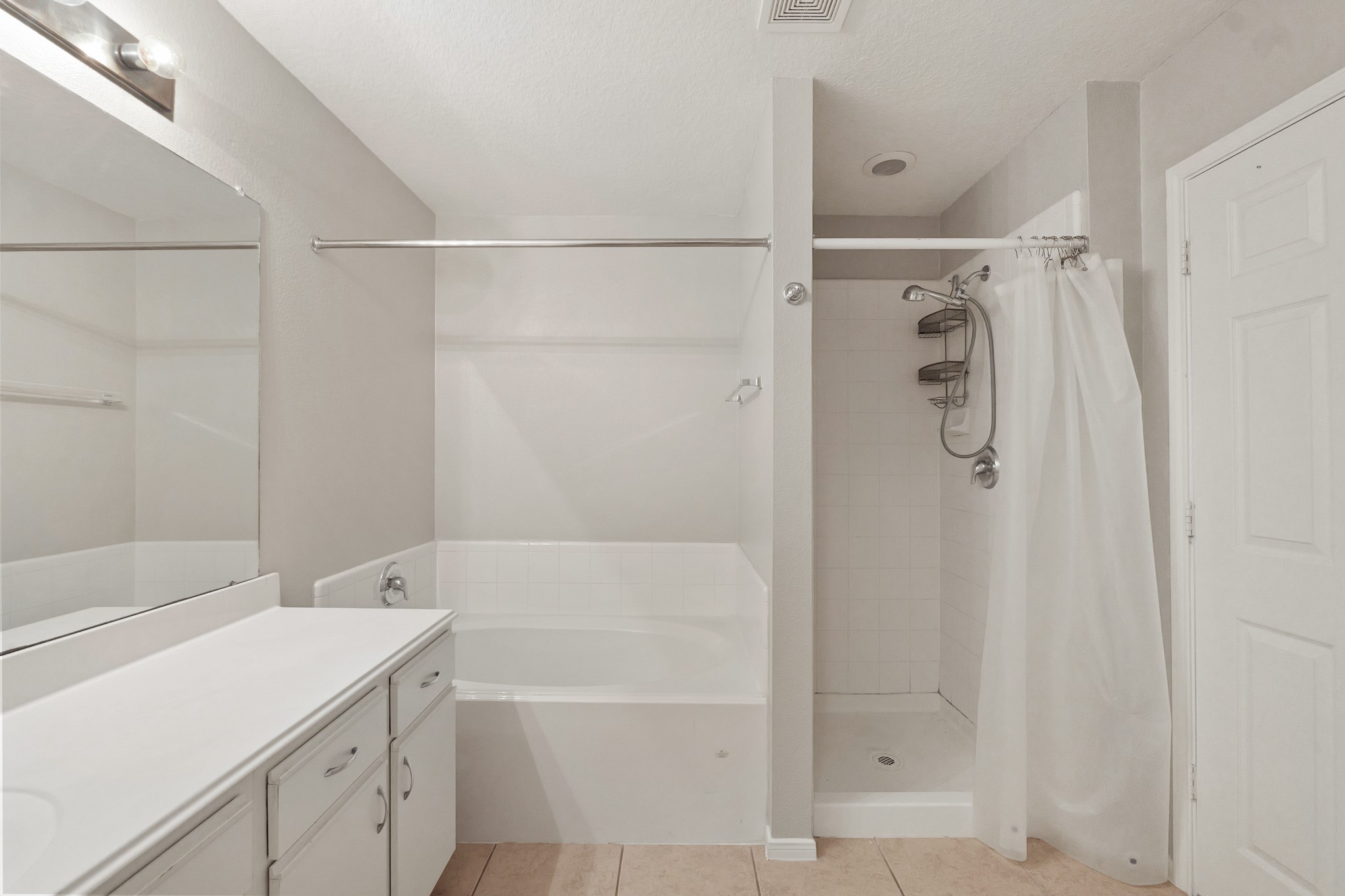 20410 Fall Foliage Drive Humble, TX 77338 - Photo 30 of 35 a bathroom with a bathtub and a shower
