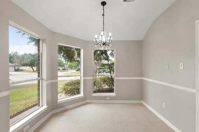 a view of a room with window wooden floor and front door