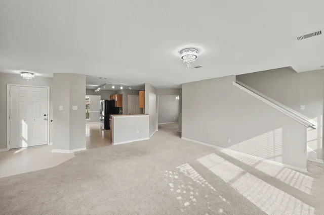 a view of living room with stainless steel appliances with kitchen countertop
