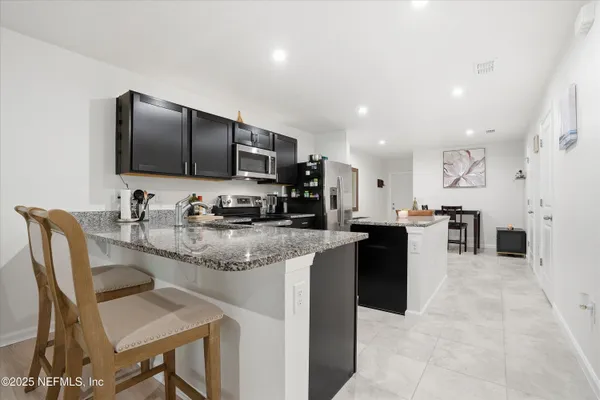 a kitchen with granite countertop counter top space appliances and cabinets
