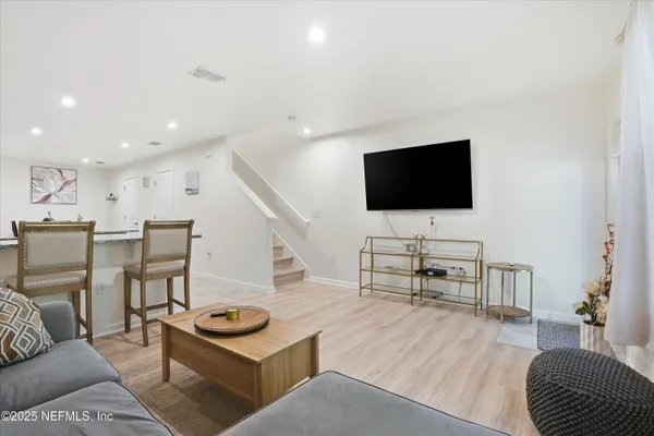 a living room with furniture and a flat screen tv