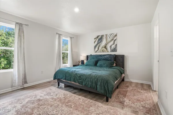a spacious bedroom with a bed and a window