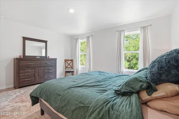 a bedroom with a bed and a dresser