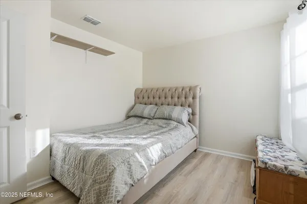 a bedroom with a bed and chair