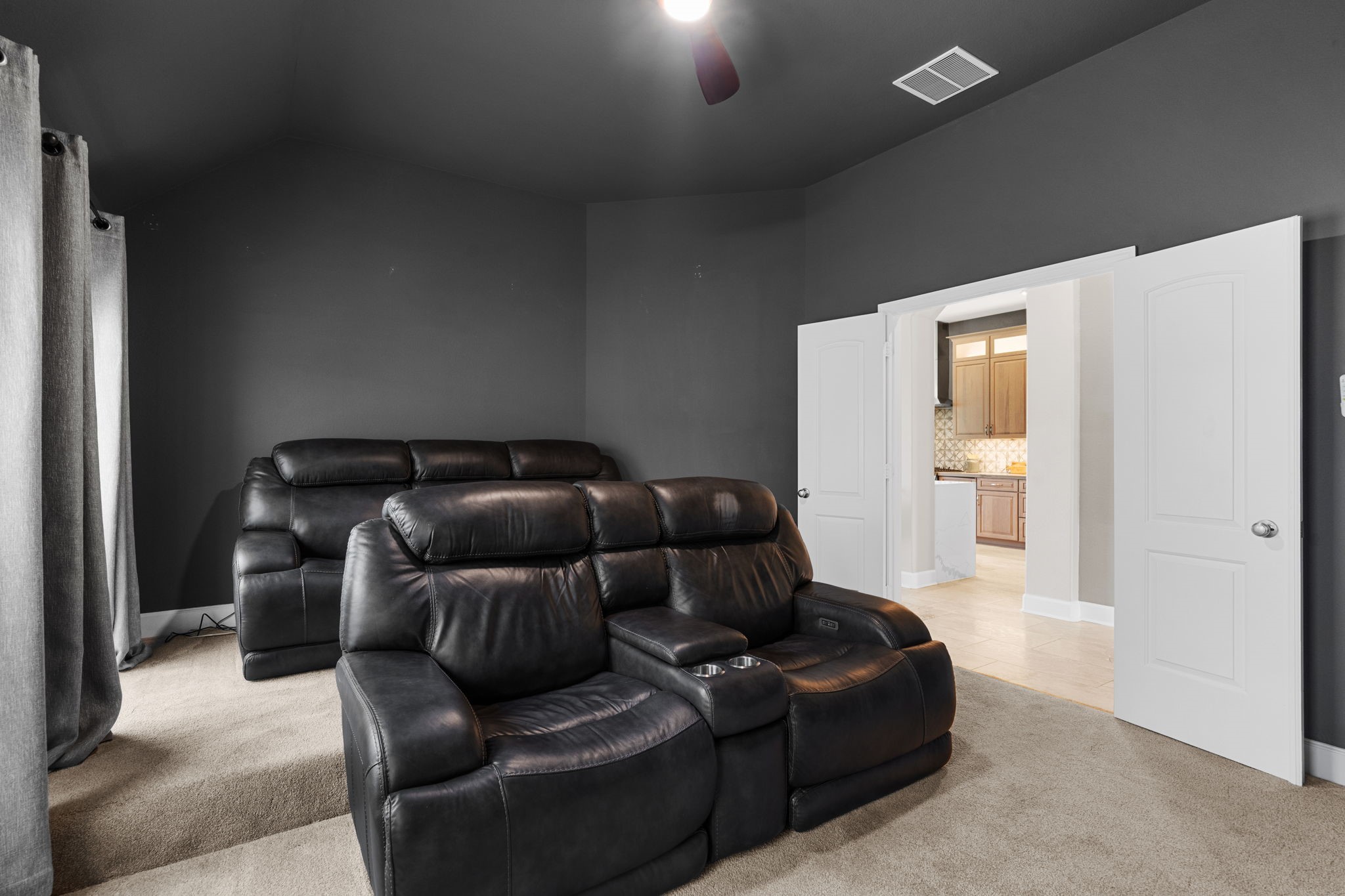 3426 Summer Ranch Drive Katy, TX 77494 - Photo 18 of 48 The media room is designed for the ultimate movie-night experience, featuring rich, dark tones, plush carpeting, and a spacious layout perfect for a full entertainment setup.