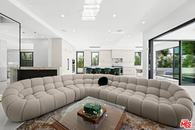 a kitchen with granite countertop a stove and a white cabinets