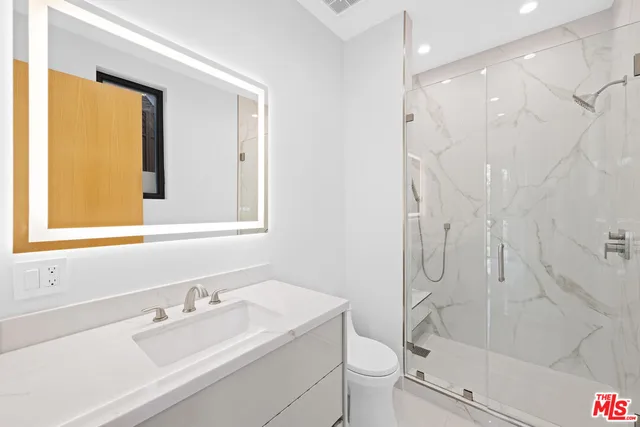 a spacious bedroom with a large bed and a large window