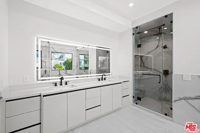a kitchen with a sink a counter space and wooden cabinets