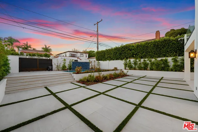 a front view of a house with palm trees
