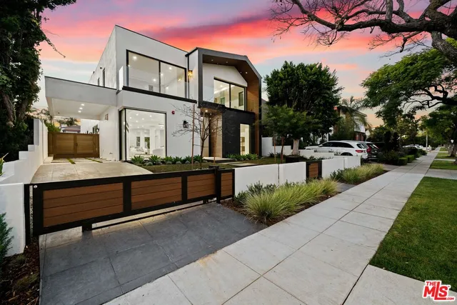 a kitchen with stainless steel appliances kitchen island granite countertop a sink and a refrigerator