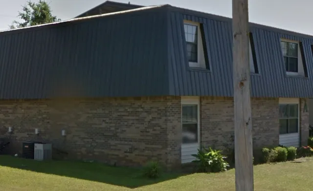 a brick building with a black door