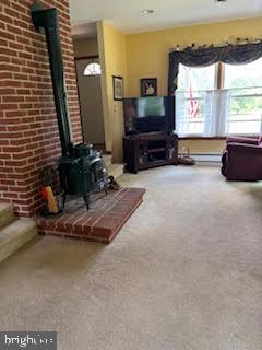 210 Brownbacks Church Road Spring City, PA 19475 - Photo 2 of 5 a living room with furniture a flat screen tv and a large window