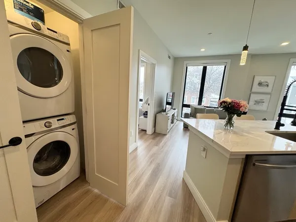 a view of a kitchen with a sink and a washer dryer