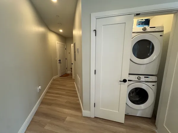 a view of a hallway with washer and dryer